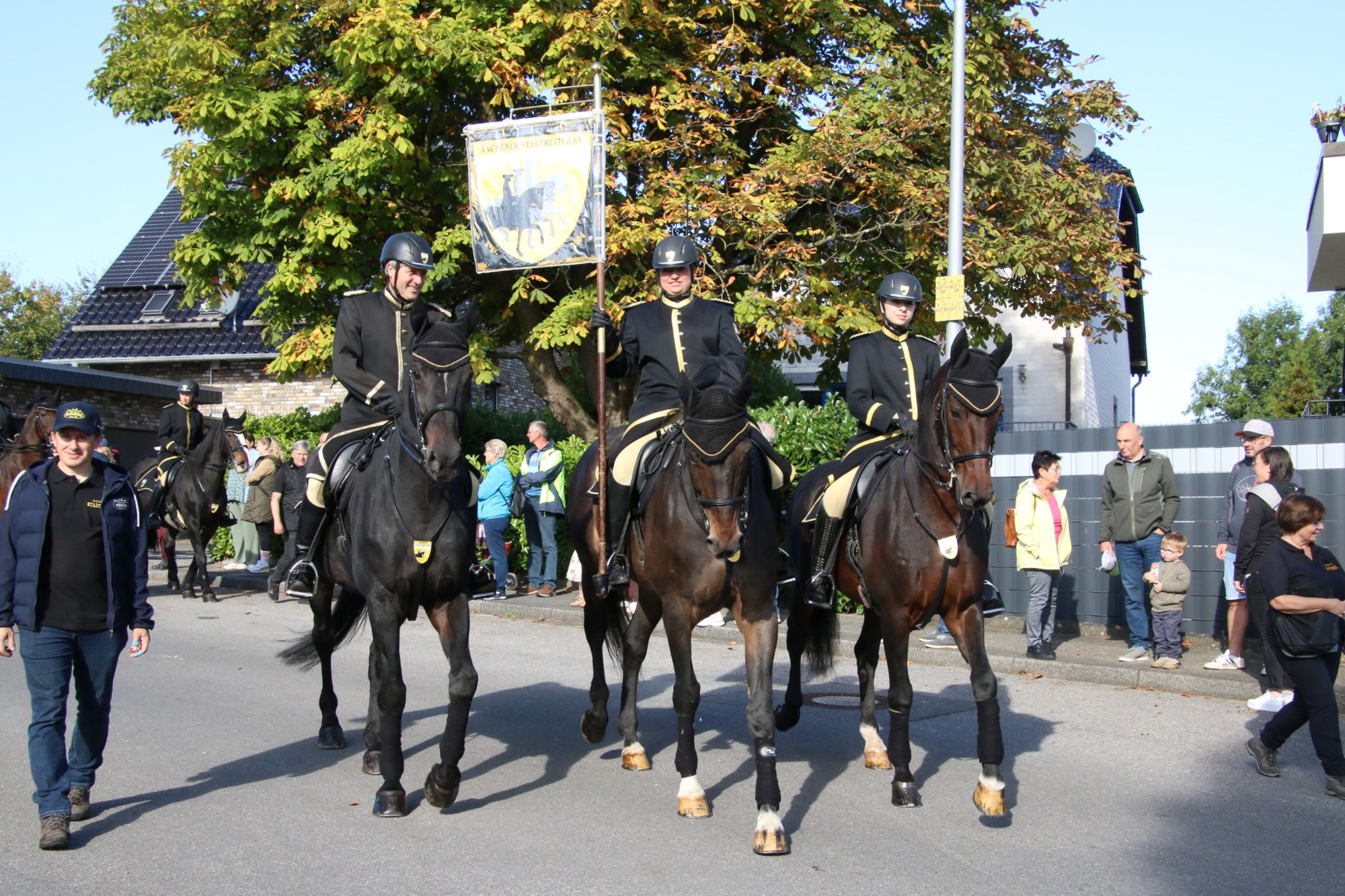 Reiter auf dunklen Pferden vor Zuschauern beim Erntedankzug Walheim 2026.