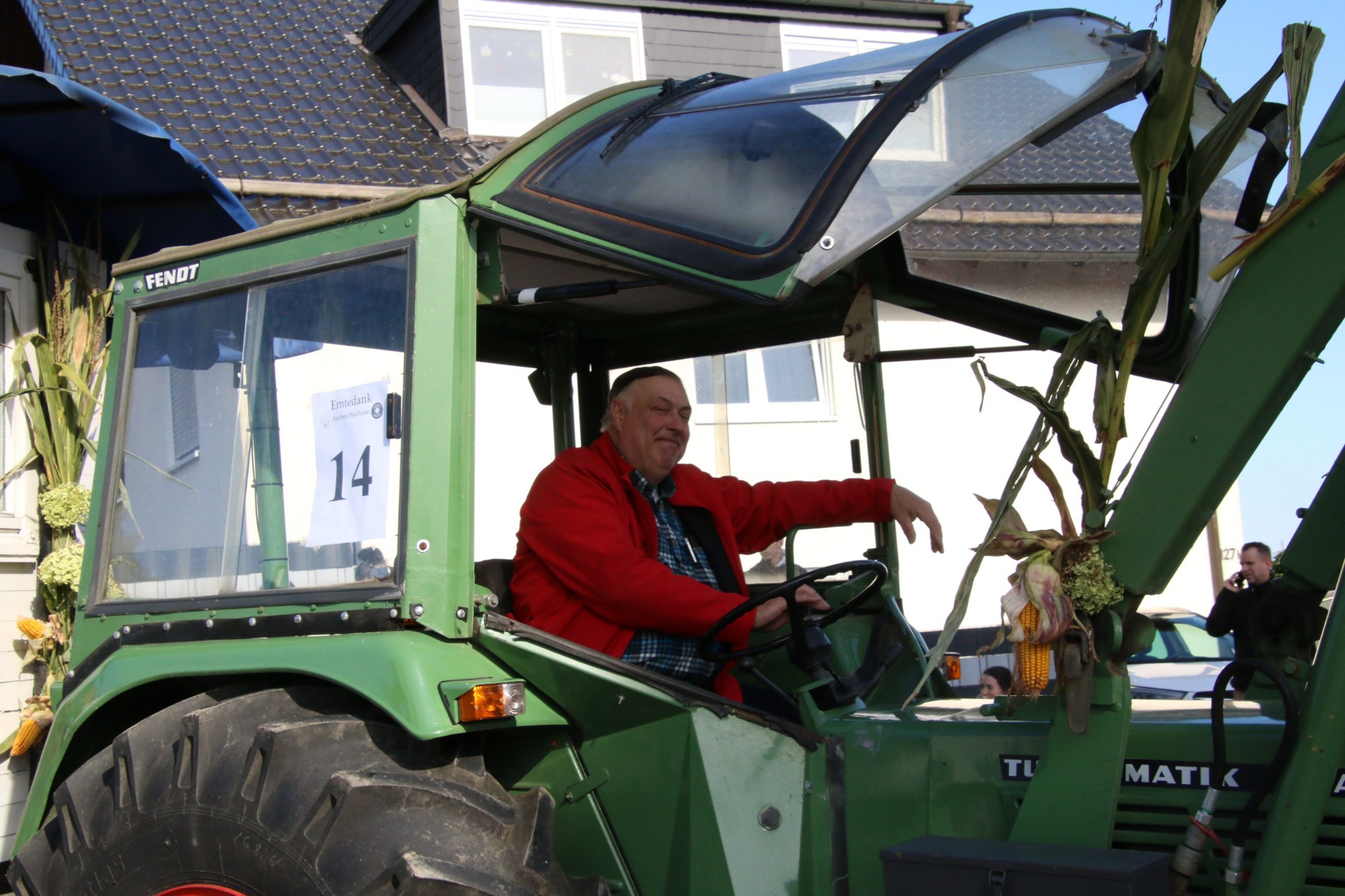 Traktorfahrer in rotem Oberteil beim Erntedankzug Walheim 2026.