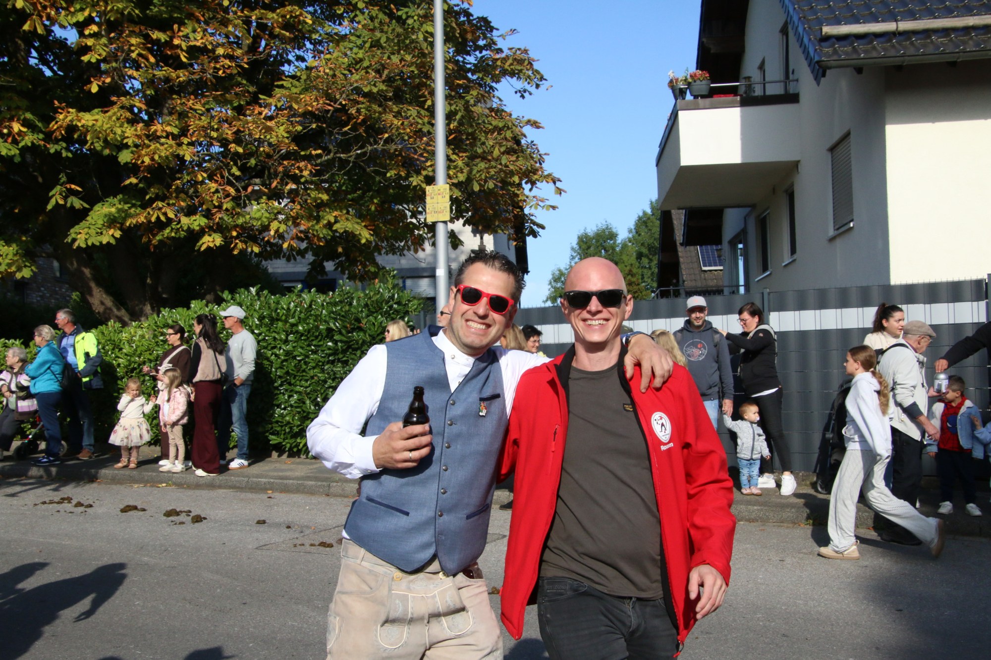 Zwei Teilnehmer mit Getränken beim Erntedankzug Walheim 2026.